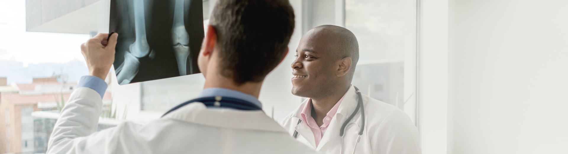 A person wearing a mask and scrubs